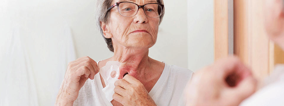 woman taking care of her neck stoma